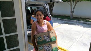 My students unload milk Casa Hogar Maximo